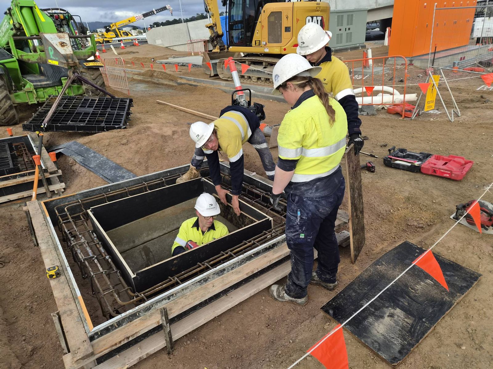 Crew installing a pit